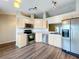 Updated kitchen featuring stainless steel appliances, light wood cabinets, and lots of natural light at 7713 Manor Dr, Lakeland, FL 33810