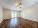 Spacious living room with wood-look floors, neutral walls, and a ceiling fan at 7713 Manor Dr, Lakeland, FL 33810
