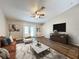 Spacious living room with wood floors, plenty of natural light, and neutral paint at 7713 Manor Dr, Lakeland, FL 33810