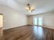 Living room with high ceilings, ceiling fan, and access to the patio at 7713 Manor Dr, Lakeland, FL 33810
