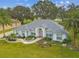 Charming single-story home featuring a well-manicured lawn and palm trees at 5407 County Road 125, Wildwood, FL 34785