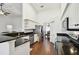 Bright kitchen featuring granite countertops, stainless steel appliances, and ample cabinet space at 5407 County Road 125, Wildwood, FL 34785