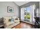 Cozy living room with hardwood floors, a large window, and neutral-toned walls at 5407 County Road 125, Wildwood, FL 34785