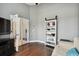 Cozy living room with hardwood floors, built-in bookshelf, and french doors to another room at 5407 County Road 125, Wildwood, FL 34785