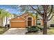 Charming one-story home featuring a two-car garage, well-maintained landscaping, and inviting curb appeal at 1029 Orange Cosmos Blvd, Davenport, FL 33837