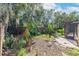 Landscaped backyard featuring a fenced area and screened patio at 4042 Stonehenge Rd, Mulberry, FL 33860