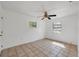 Empty bedroom featuring tile floors and a ceiling fan at 4042 Stonehenge Rd, Mulberry, FL 33860