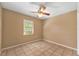 Bright bedroom with tile floors and ceiling fan at 4042 Stonehenge Rd, Mulberry, FL 33860