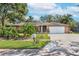 Brick house with a two-car garage and landscaped yard at 4042 Stonehenge Rd, Mulberry, FL 33860