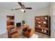 Home office with built-in shelving and view to kitchen at 4042 Stonehenge Rd, Mulberry, FL 33860