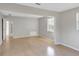 Light grey bedroom with wood floors and access to other rooms at 836 Kensington St, Lakeland, FL 33803