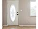 Bright entryway with hardwood floors and a white door with a decorative glass insert at 836 Kensington St, Lakeland, FL 33803