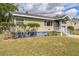 One-story house featuring a light green exterior, neatly trimmed landscaping, and a covered entrance at 836 Kensington St, Lakeland, FL 33803