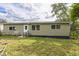 Ranch-style home with green siding, backyard, and ramp access at 836 Kensington St, Lakeland, FL 33803