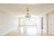 Living room with hardwood floors, chandelier, and built-in shelving at 836 Kensington St, Lakeland, FL 33803