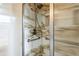 Walk-in shower with marble tile and glass enclosure at 836 Kensington St, Lakeland, FL 33803