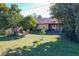 Backyard with green grass and mature trees at 3017 Jon Jon Ct, Orlando, FL 32822