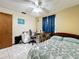 Bedroom with a bed, desk, and ceiling fan at 3017 Jon Jon Ct, Orlando, FL 32822