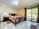 Bright bedroom with a queen-size bed and patio access at 3017 Jon Jon Ct, Orlando, FL 32822