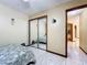Bedroom with a bed, mirrored closet doors, and access to hallway at 3017 Jon Jon Ct, Orlando, FL 32822