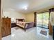Bright bedroom with tiled floors and sliding glass doors leading to the outdoors at 3017 Jon Jon Ct, Orlando, FL 32822