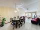 Dining room with a large table and chairs, adjacent to the living room at 3017 Jon Jon Ct, Orlando, FL 32822