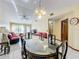 Dining room with an oval table and chairs, near the living room and entry at 3017 Jon Jon Ct, Orlando, FL 32822