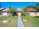 Front view of a condo with a landscaped yard and walkway at 3017 Jon Jon Ct, Orlando, FL 32822