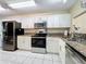 Modern kitchen with stainless steel appliances and granite counters at 3017 Jon Jon Ct, Orlando, FL 32822