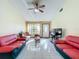 Living room with red couches and a view of the front door at 3017 Jon Jon Ct, Orlando, FL 32822