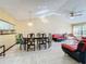Open concept living and dining area with red sofas at 3017 Jon Jon Ct, Orlando, FL 32822