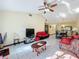 Living room with red couches and a view of the dining area at 3017 Jon Jon Ct, Orlando, FL 32822