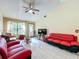 Living room with red couches and a view of the front door at 3017 Jon Jon Ct, Orlando, FL 32822