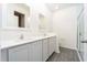 Bathroom features dual sinks, modern cabinetry, stone countertops, and a glass shower at 13490 Leaping Water Way, Astatula, FL 34705