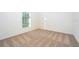 Empty bedroom features neutral carpet, window with blinds, and fresh paint at 13490 Leaping Water Way, Astatula, FL 34705