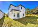 New construction home featuring white siding, dark trim, a covered porch, and a spacious yard at 13490 Leaping Water Way, Astatula, FL 34705