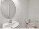 Neat half bathroom featuring a circular mirror, contemporary fixtures, and a toilet at 4432 Sw 84Th Street Rd, Ocala, FL 34476