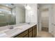 Modern bathroom with a dual sink vanity, tile flooring, and a walk-in glass shower at 4432 Sw 84Th Street Rd, Ocala, FL 34476
