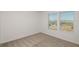 Bright bedroom with neutral carpet, two windows and white trim at 4432 Sw 84Th Street Rd, Ocala, FL 34476