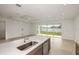 Modern kitchen featuring a quartz countertop island with a stainless steel dishwasher at 4432 Sw 84Th Street Rd, Ocala, FL 34476