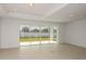 Bright living room with expansive sliding glass doors offering picturesque backyard views at 4432 Sw 84Th Street Rd, Ocala, FL 34476
