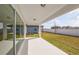 Covered patio offers views of a well-manicured lawn and a privacy fence, blending indoor and outdoor living at 4432 Sw 84Th Street Rd, Ocala, FL 34476