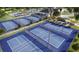 Aerial view of community pickleball courts, surrounded by lush landscaping, a pool, and clubhouse at 4432 Sw 84Th Street Rd, Ocala, FL 34476