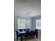 Elegant dining area with a modern chandelier and views of the backyard at 1360 Se 63Rd Court Rd, Ocala, FL 34472