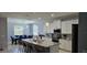 Open-concept kitchen features white cabinets, granite countertops, and stainless steel appliances at 1360 Se 63Rd Court Rd, Ocala, FL 34472