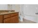 Bathroom featuring a vanity with granite countertops, tile floors and a shower and tub combo at 3825 Quaint Ln # C, Clermont, FL 34711