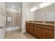 Bathroom featuring double vanity, granite countertops, and a glass enclosed shower at 3825 Quaint Ln # C, Clermont, FL 34711