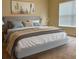 Relaxing bedroom featuring a bed with neutral linens, and a large window for natural light at 3825 Quaint Ln # C, Clermont, FL 34711