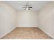 A spacious, empty bedroom featuring tile floors and a ceiling fan with overhead lighting at 3825 Quaint Ln # C, Clermont, FL 34711
