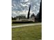 Attractive clubhouse sign featuring decorative accents and lush landscaping at 3825 Quaint Ln # C, Clermont, FL 34711